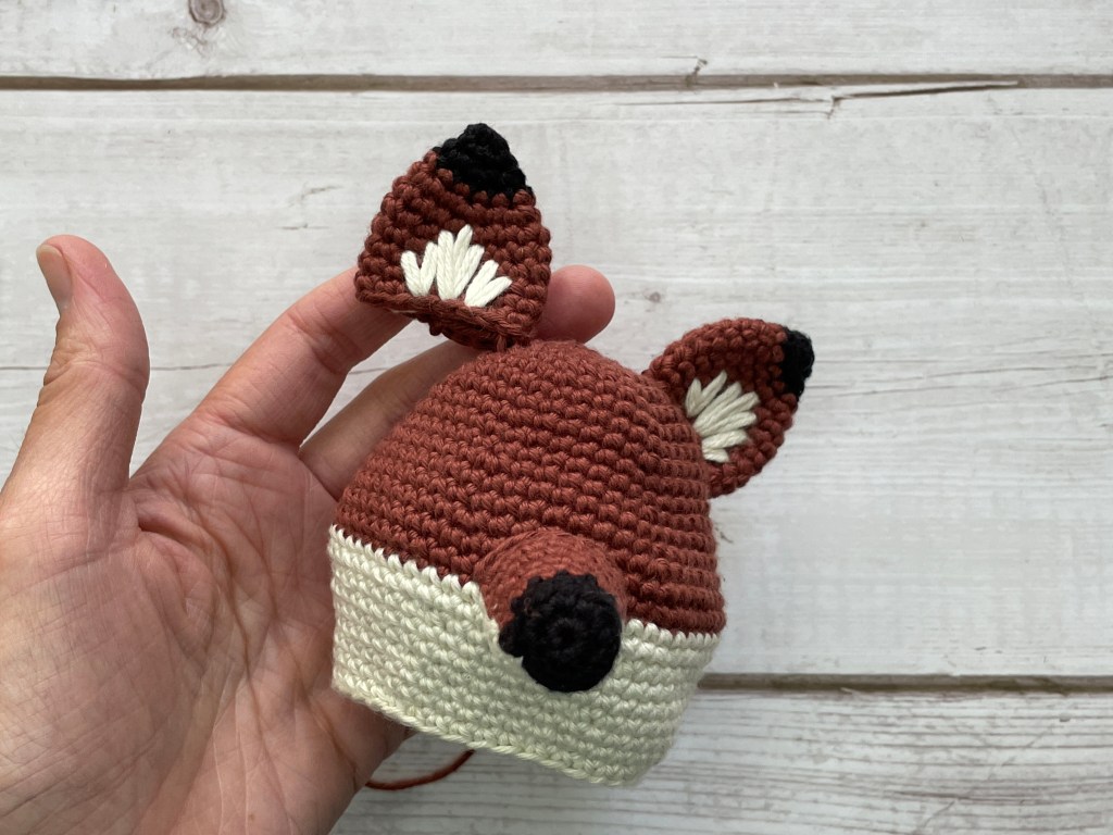 Fox crochet pattern in the making - sewing on ears