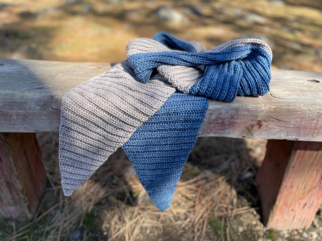 crochet scarf sitting on bench